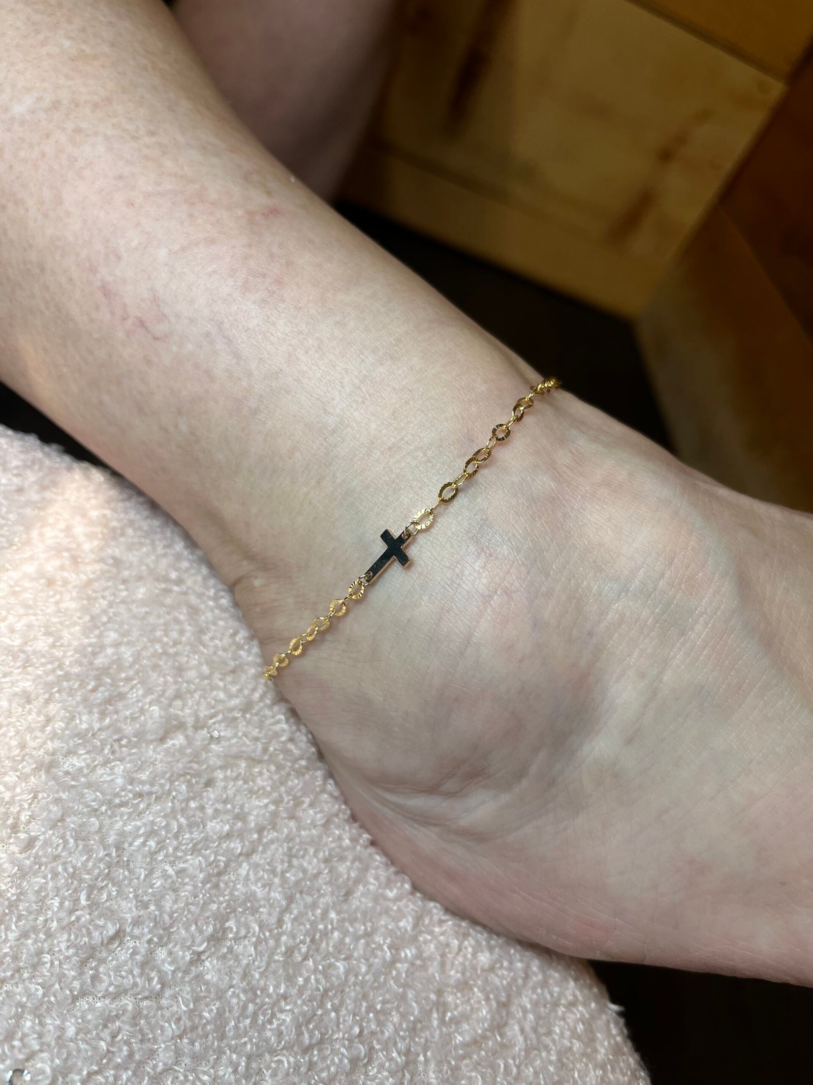 Gold anklet with a cross charm