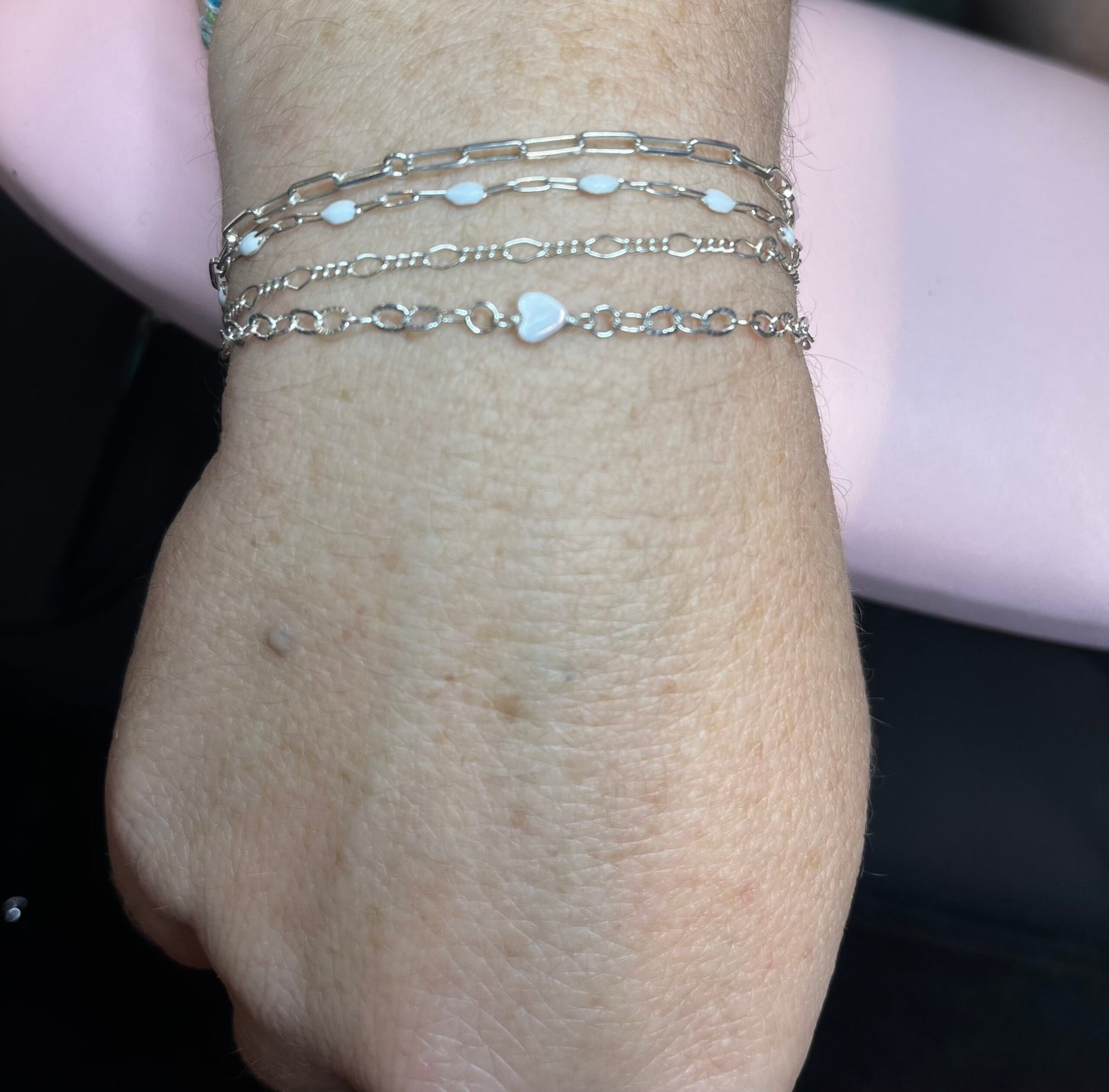 Layered silver bracelets with a heart connector