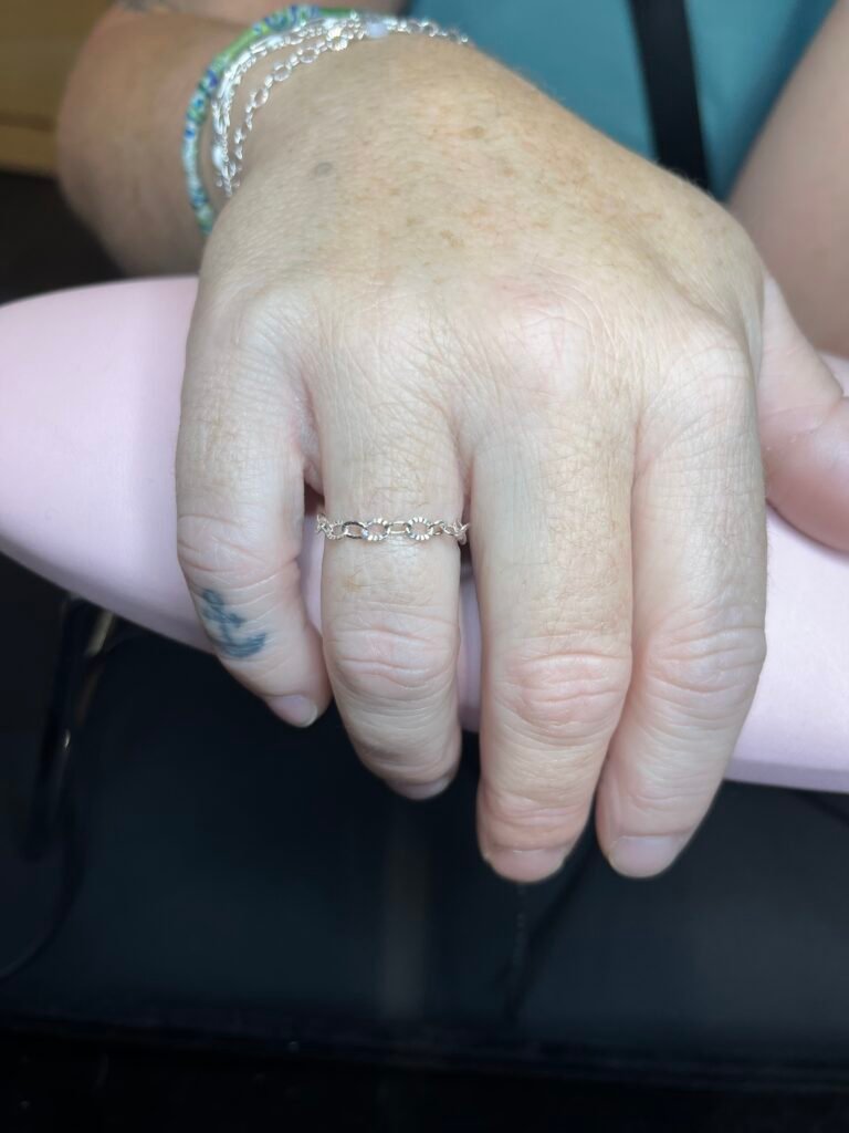 Fine silver permanent ring on a customer’s hand