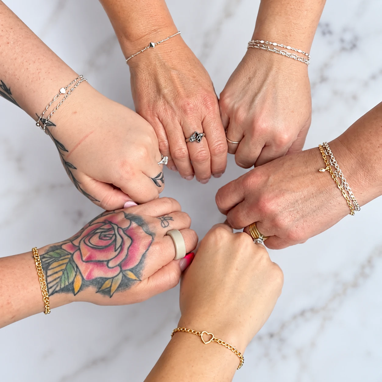 Friends showing their permanent bracelets together